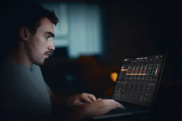 A cheerful woman in traditional clothing using her smartphone during a festive moment, showing how easily the ZS777 app fits into everyday life.